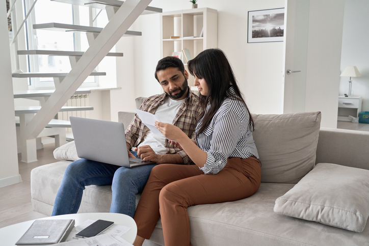 A couple reviewing different tax documents.