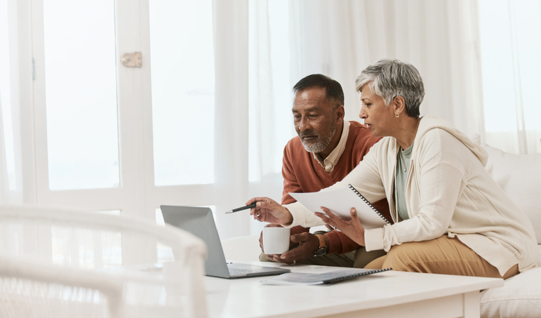 A senior couple reviews their Social Security benefits.